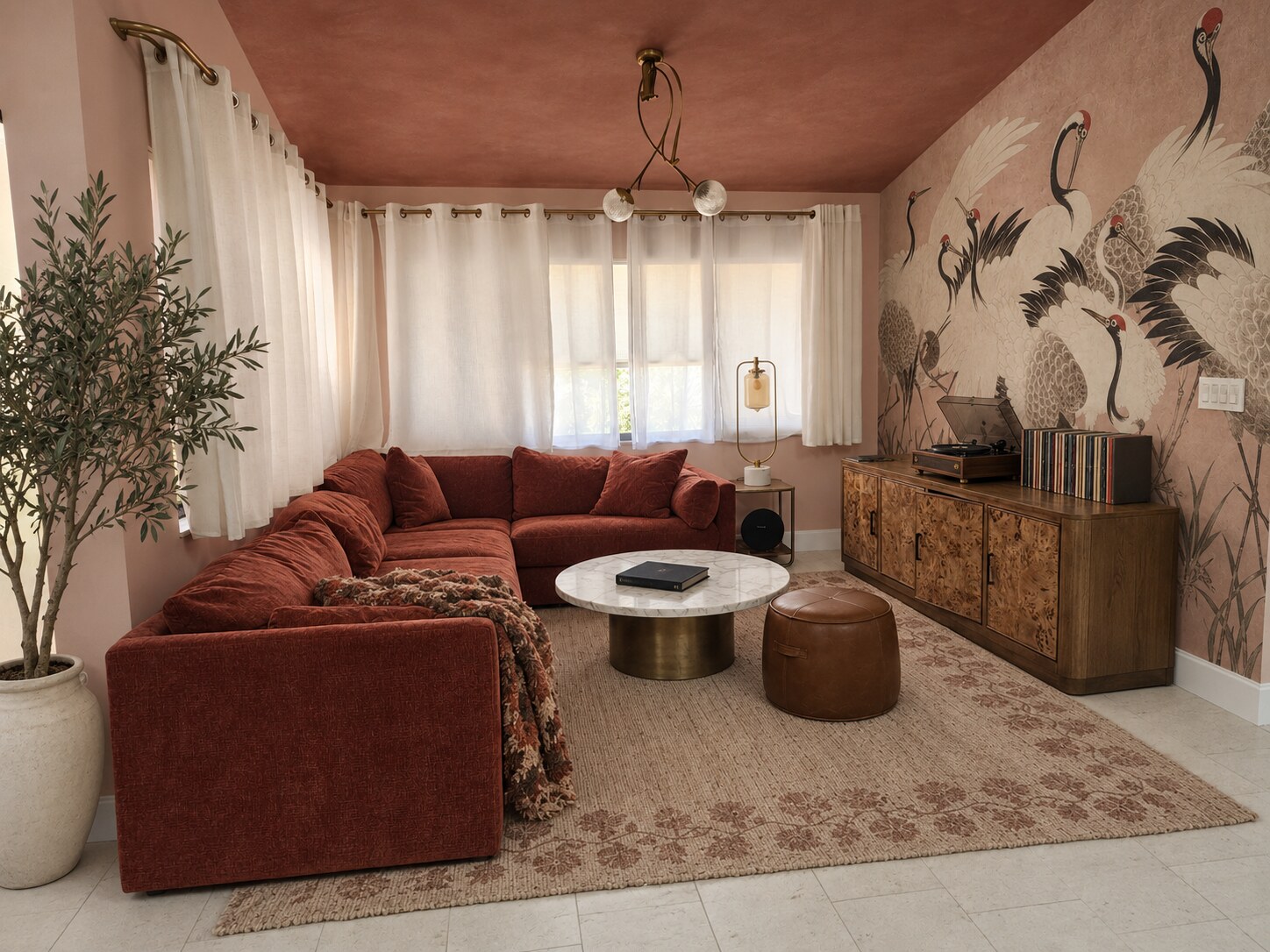 Living room with a crane mural, rust sectional and vintage record console